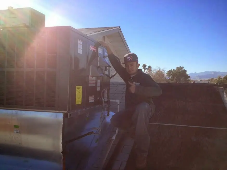 HVAC technician performing AC Tune-Up on a rooftop unit in Floral City